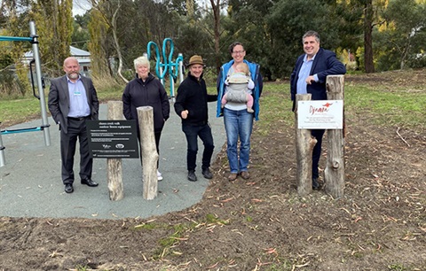 Councillors and community member standing in front of the outdoor fitness equipment