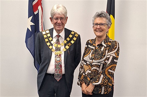 Cr Don Henderson and Cr Lesley Hewitt standing in front of the Australian National flag and the Aboriginal flag