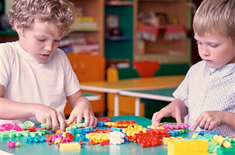 Children playing with blocks on a table