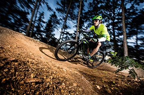 man riding a mountain bike on a track