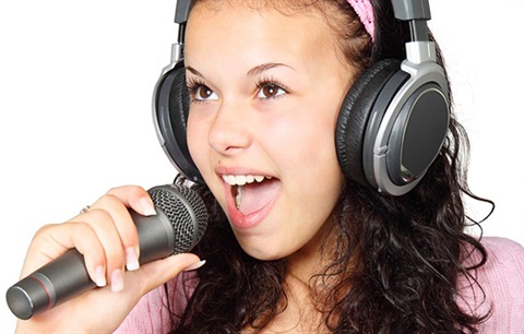 a young person speaking into a microphone