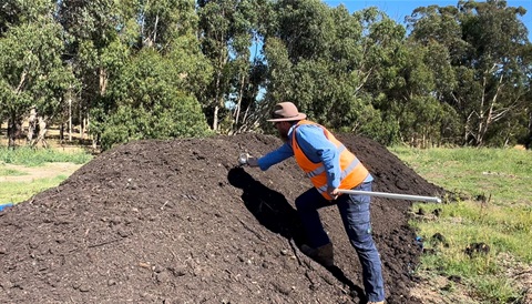 Matthew Daniel and compost pile.jpg